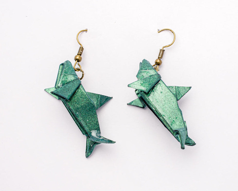 arete de origami en forma de tiburón hecho en papel verde con resina